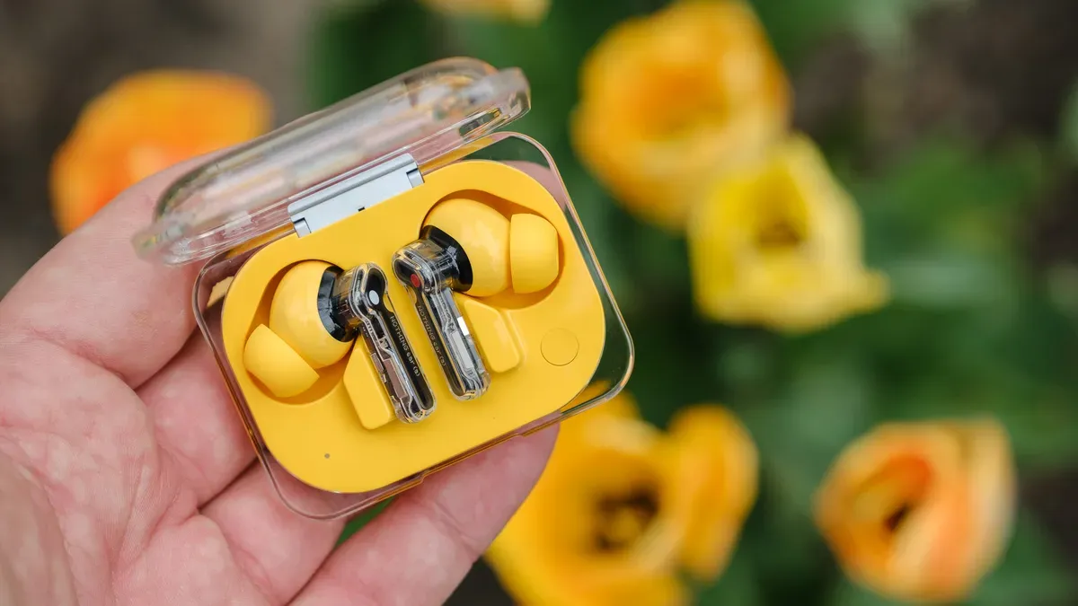 Nothing Ear (a) wireless earbuds in bright yellow with translucent charging case