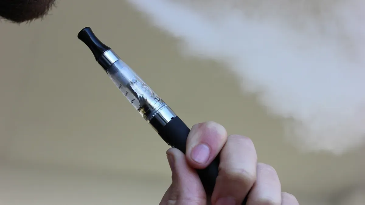 A person using an e-cigarette, with a focus on health implications for smoking cessation