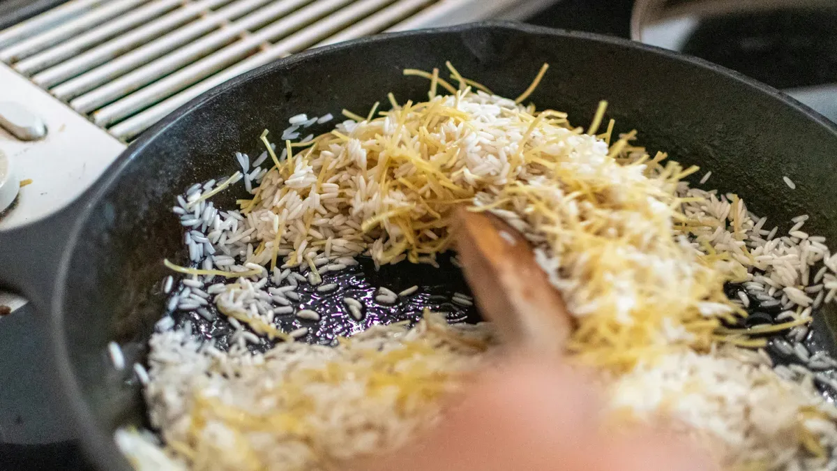A bowl of rice with a droplet of water, symbolizing efforts to reduce arsenic exposure through cooking methods